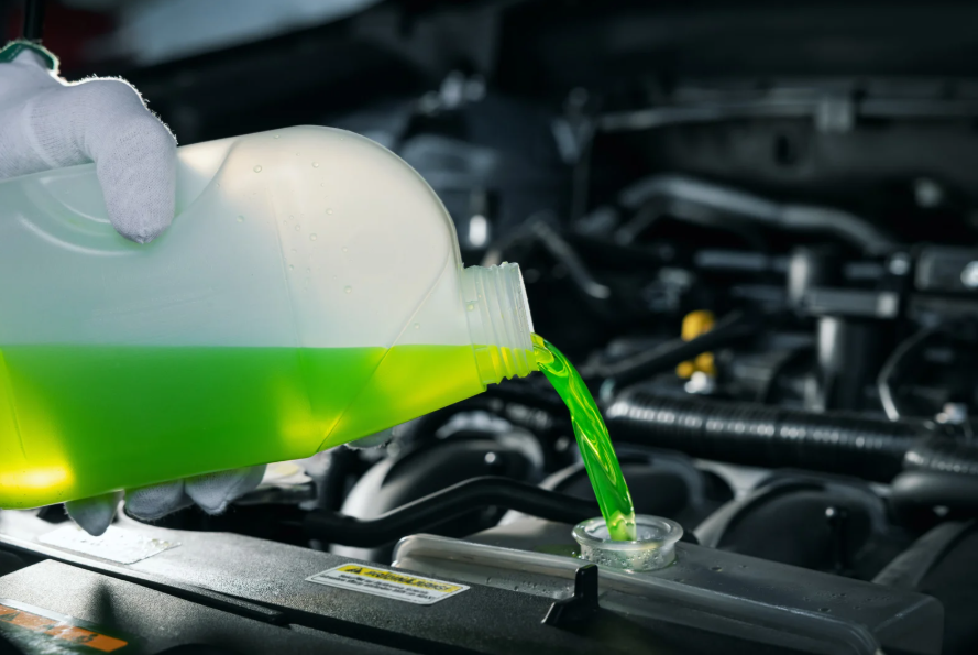 Pouring green coolant into an engine
